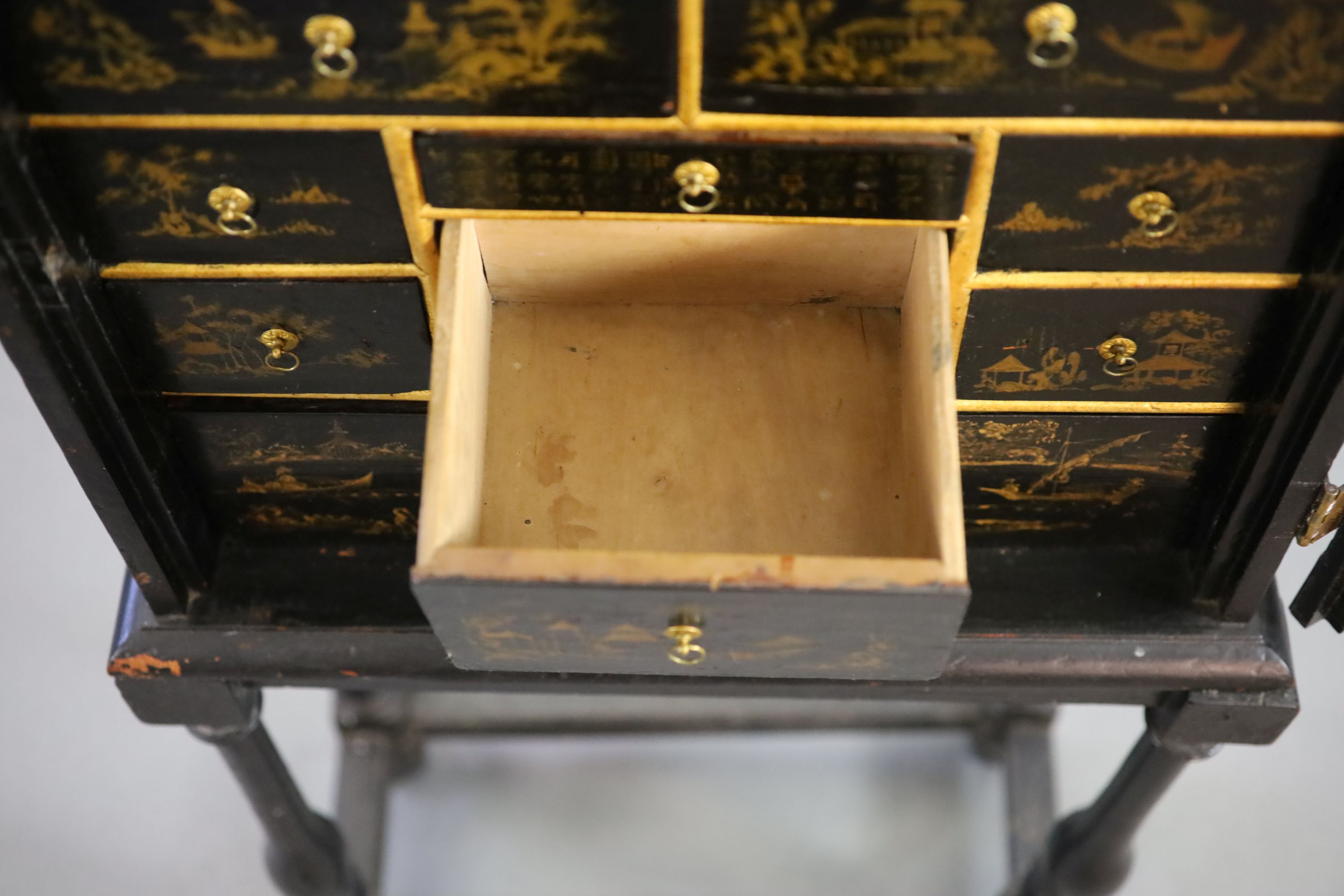 An early 18th century European japanned cabinet on stand, W.54cm D.24cm H.115.5cm